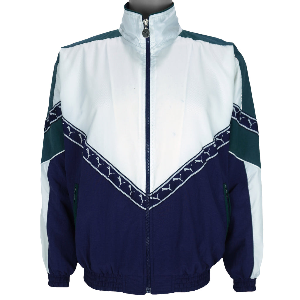 1990s vintage Puma colorblock taped logo windbreaker. Dark blue, green and white in color, fitting medium in size and in excellent condition.