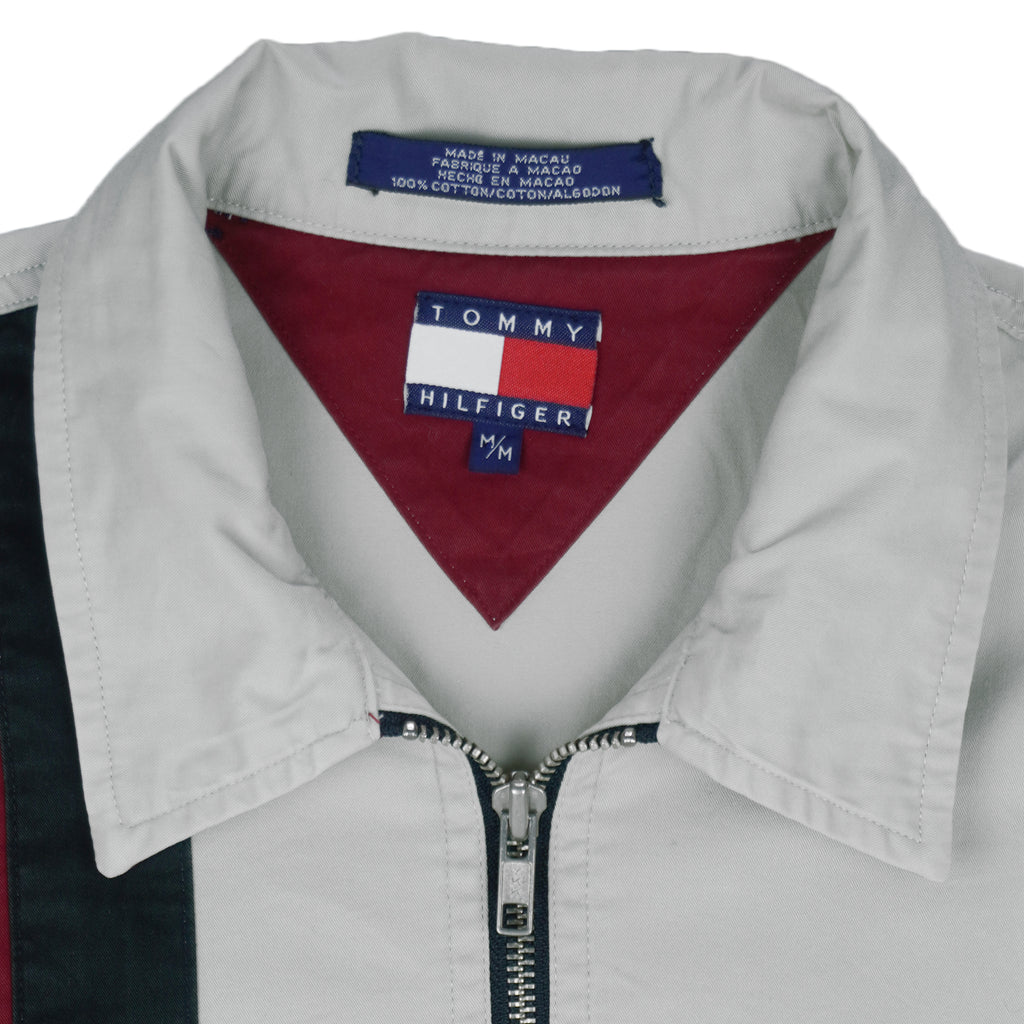 1990s vintage Tommy Hilfiger Racing work jacket. Beige in color with red and black stripes down right side and sleeves. Embroidered Hilfiger Motorcycles logo on front, back and left sleeve, Medium in size and in excellent condition.