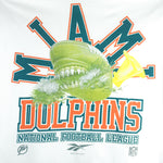 1994 vintage Reebok NFL Miami Dolphins spell-out T-Shirt. White in color with image of a football with teeth on front and Reebok logo on left sleeve, fits X-Large in size and is in excellent condition.