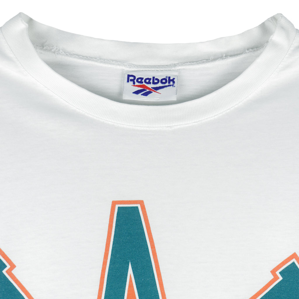 1994 vintage Reebok NFL Miami Dolphins spell-out T-Shirt. White in color with image of a football with teeth on front and Reebok logo on left sleeve, fits X-Large in size and is in excellent condition.