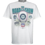 2003 vintage MLB Seattle Mariners "Road to the Show" spell-out T-Shirt by Gildan. White in color with farm team logos (Everett Aquasox, Wisconsin Timber Rattlers, Inland Empire 66ers of San Bernardino, San Antonio Missions, Tacoma Rainiers), Medium in size and is in excellent condition.