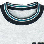 1990s vintage NHL San Jose Sharks embroidered T-Shirt by Nutmeg Mills. Grey in color with black and teal collar, fits Large in size and is in excellent condition.