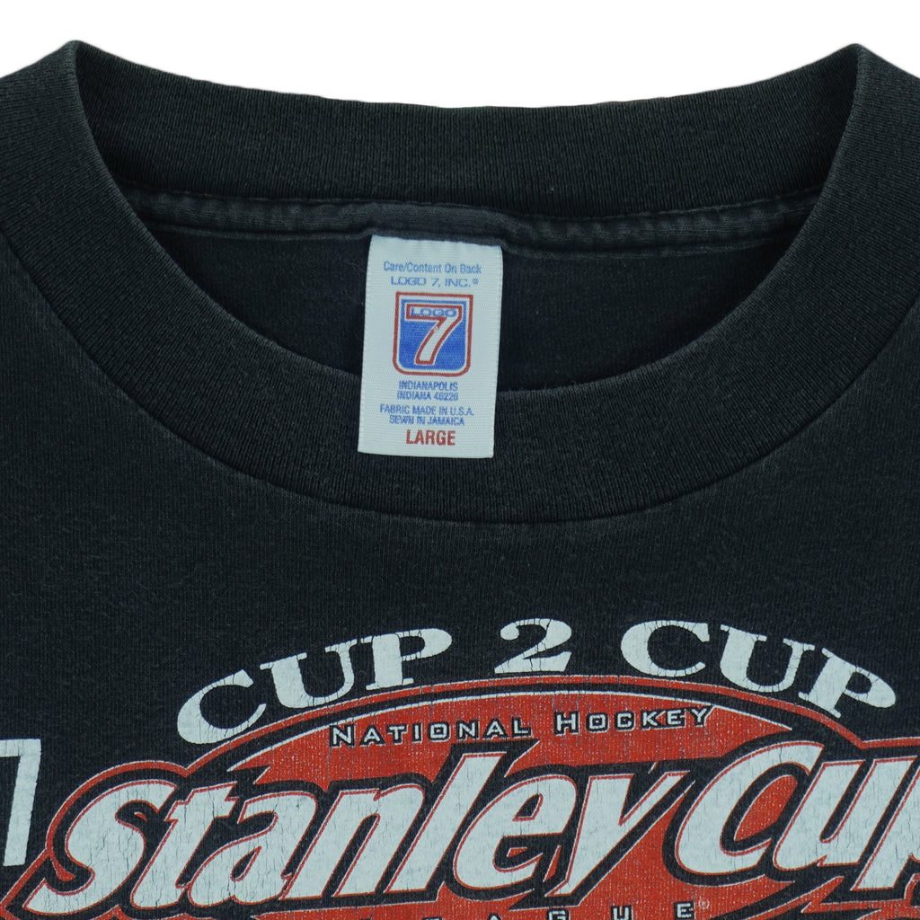 1998 vintage NHL Detroit Red Wings Stanley Cup Champions 97-98 T-Shirt by Logo 7. Black in color with big printed graphic and spell-out on front: Cup 2 Cup, Nine for All Time. Large in size and is in excellent condition.