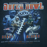 2005 vintage NFL Super Bowl XXXIX New England Vs Eagles by Players Inc. Dark blue in color with Tom Brady and Donovan McNabb on front, fits Medium in size and is in excellent condition.