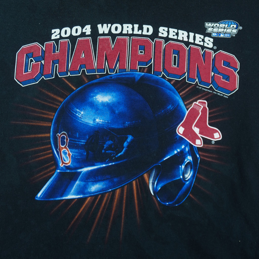 2004 vintage MLB Boston Red Sox World Series Champions T-Shirt by Delta. Black in color with spell-out and helmet graphic on front, Large in size and is in excellent condition.