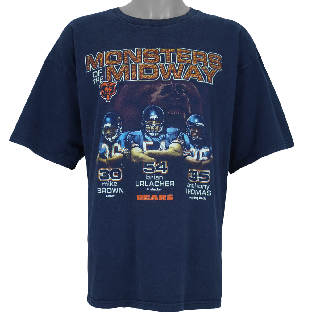 1990s Vintage NFL Chicago Bears Monsters of the Midway spell-out T-Shirt by Lee Sport. Dark blue in color with player images on front: Anthony Thomas, Brian Urlacher and Mike Brown, XX-Large in size and in excellent condition.