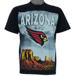 1990s vintage NFL Arizona Cardinals spell-out T-Shirt. Black in color with large full-screen print of the sandstone pillars in Monument Valley on front and "Arizona" text on back, fits Medium in size and is in excellent condition.