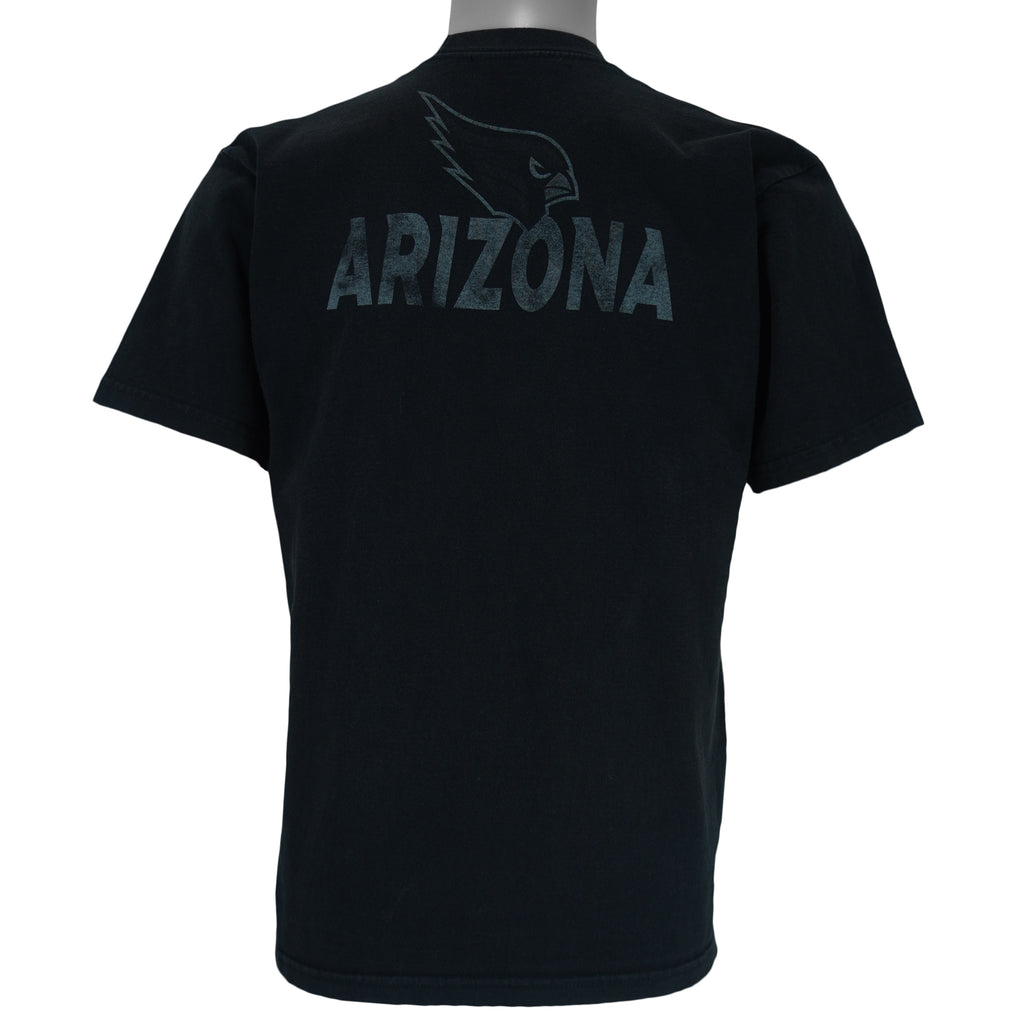 1990s vintage NFL Arizona Cardinals spell-out T-Shirt. Black in color with large full-screen print of the sandstone pillars in Monument Valley on front and "Arizona" text on back, fits Medium in size and is in excellent condition.