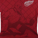 1990s vintage NHL Detroit Red Wings all over print T-Shirt. Red in color with goalie and net silhouette, and team logo on front. Fits X-Large size and in excellent condition.