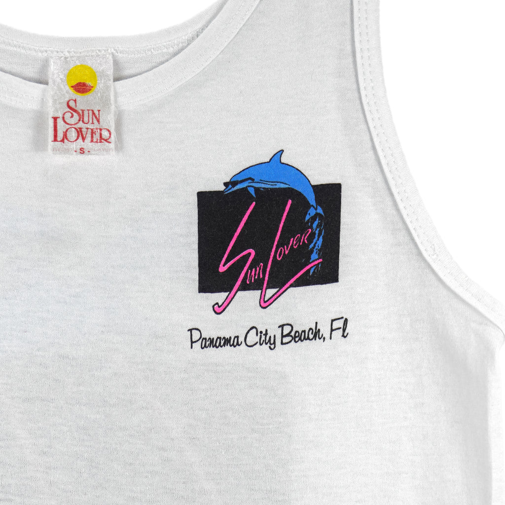 1980s vintage Panama City Beach, Florida, sleeveless shirt by Sun Lover. White in color with big printed graphic of dolphins wearing sunglasses on back and a smaller version on front, tagged size Small, and is in excellent condition.