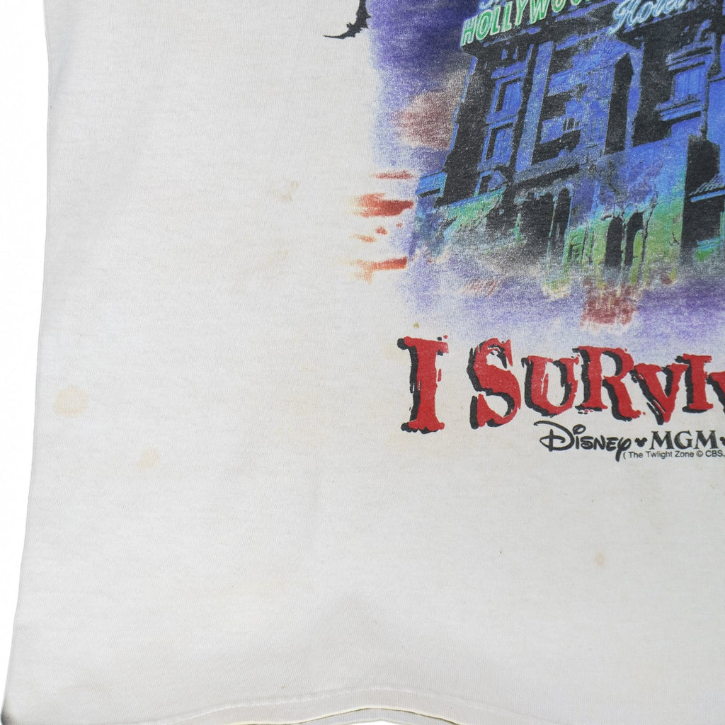 Vintage Walt Disney World "I Survived!" The Twilight Zone Tower of Terror sleeveless shirt. White in color with big printed graphic of The Hollywood Tower Hotel, tagged size X-Large, and is in good condition.