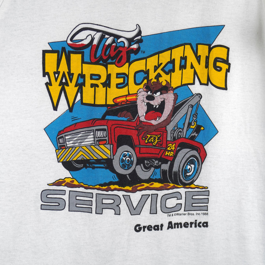 1988 vintage Looney Tunes Taz's Wrecking Service sleeveless shirt by Tee Jays. White in color with big printed graphic of the Tazmanian Devil in a tow truck, tagged size Medium, and is in excellent condition.