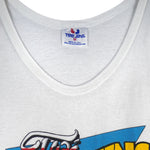 1988 vintage Looney Tunes Taz's Wrecking Service sleeveless shirt by Tee Jays. White in color with big printed graphic of the Tazmanian Devil in a tow truck, tagged size Medium, and is in excellent condition.