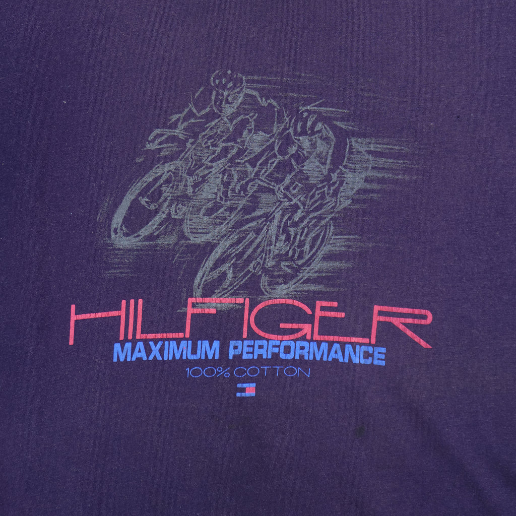 1990s vintage Tommy Hilfiger Maximum Performance 100% Cotton T-Shirt. Navy blue in color with outlines of cyclists and Hilfiger spell-out, fits size X-Large and is in excellent condition.