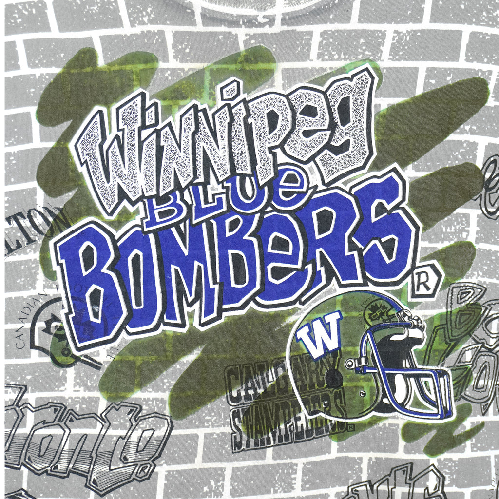 CFL (Fruit Of The Loom) - Winnipeg Blue Bombers All Over Print T-Shirt 1990s X-Large Vintage Retro Football